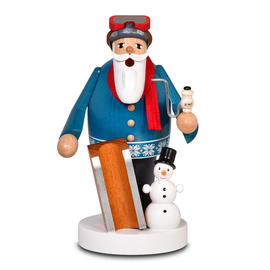 Original KWO Räuchermann Kufenkönig aus der Serie Die Bärtigen: Ein Kufenkönig aus Holz mit blauem Mantel, rotem Schal und Skibrille, neben einem kleinen Schneemann mit Zylinder auf einem weißen Sockel steht.